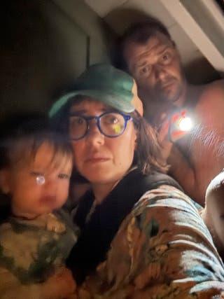 Shabd Simon-Alexander holds his one-year-old daughter, accompanied by an almanus, right and Jane Towler, not like the roof of their hunt cabin